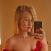 Testimonial profile photo of a female taking a selfie in a mirror